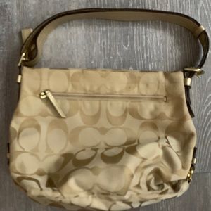 Gold and tan Coach bag. Pink inside